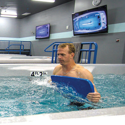 Man walking against water current in swim spa