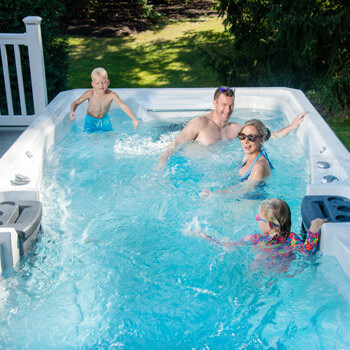 A family enjoying time together in a swim spa.