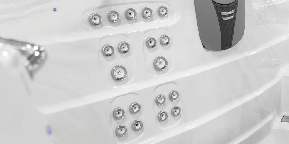 View on the inside of an H2X Fitness swim spa without water focusing on jets.