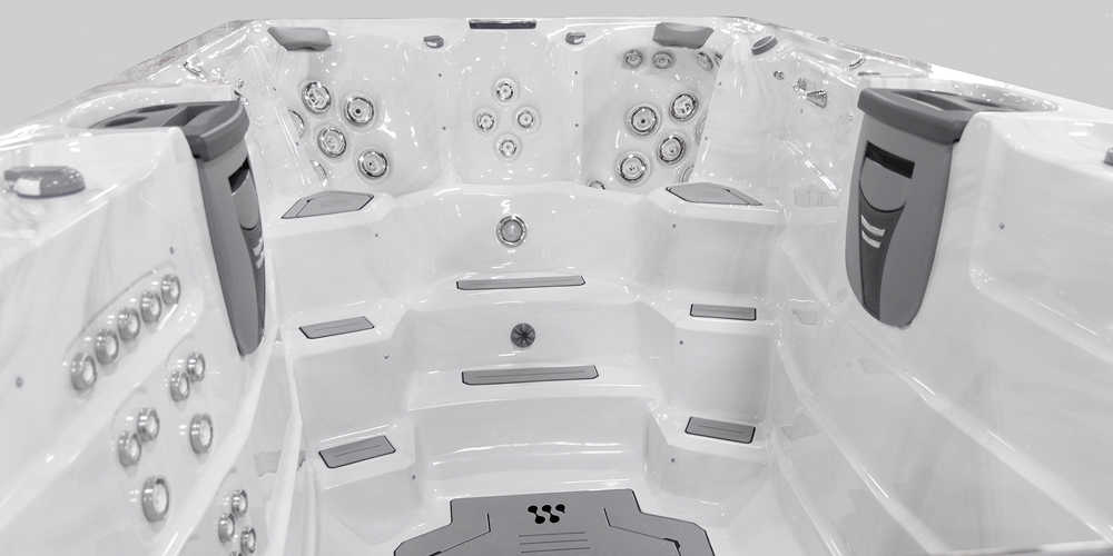 View on the inside of an H2X Fitness swim spa without water focusing on jets.
